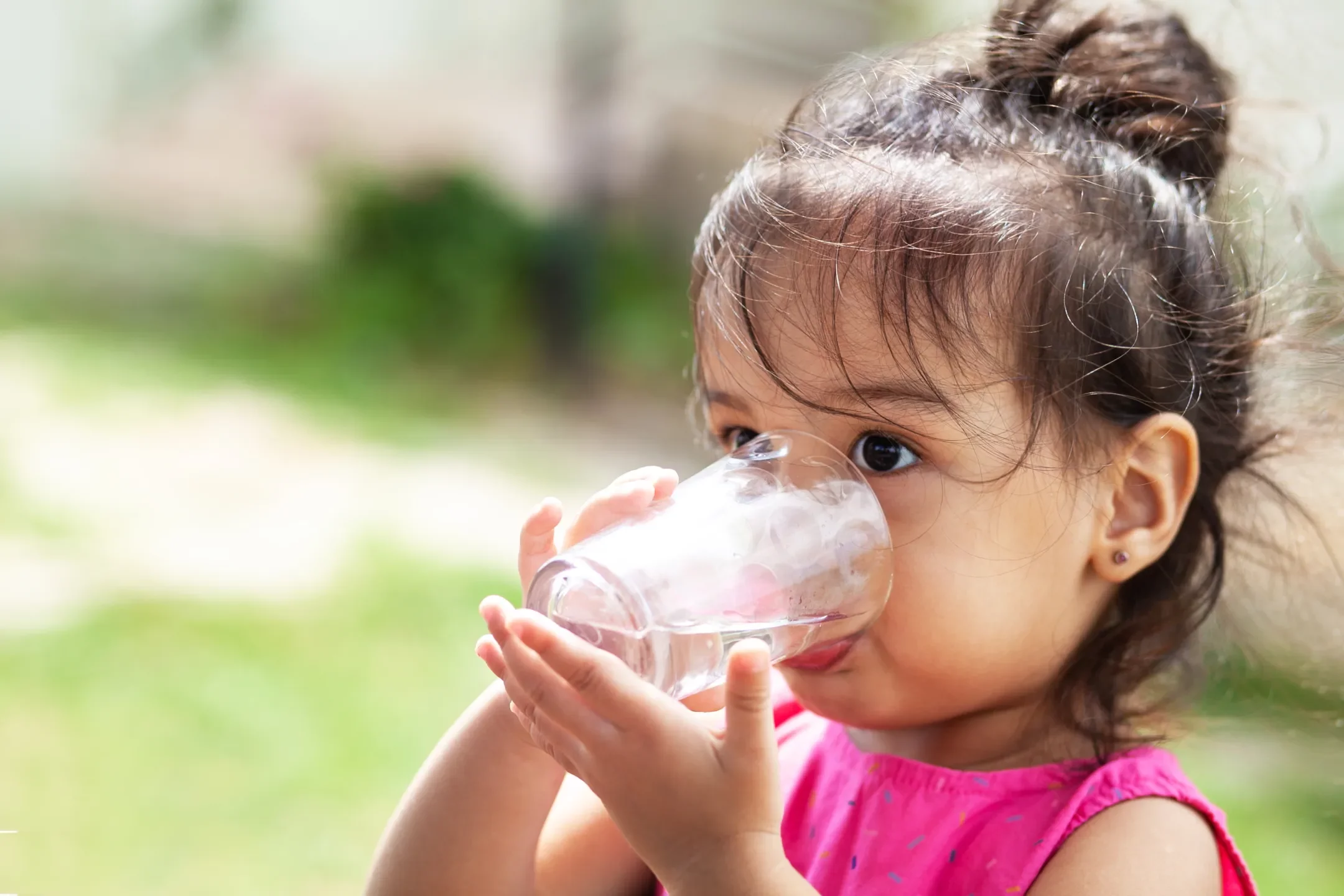 Little girl drinking clean water